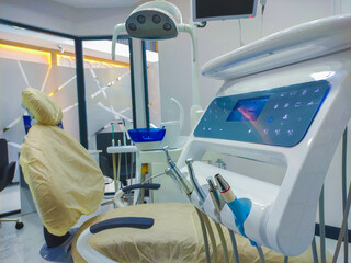 Patient chair used by  professionals for treatment and tools used by doctors in dental procedures. Dental treatment instruments and dental clinic. dental hospital and clinic © UniqDream