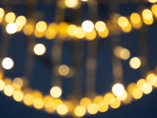bokeh of christmas lights on a dark blue background.