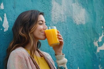 A woman enjoying a glass of orange juice