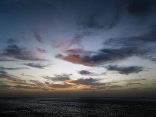Atlantic ocean sunset in Tenerife with soft golden hues illuminating the horizon.  A scene that evokes a sense of tranquility and connection with nature