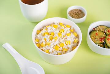 Asian corn rice in a bowl with cucumber salad