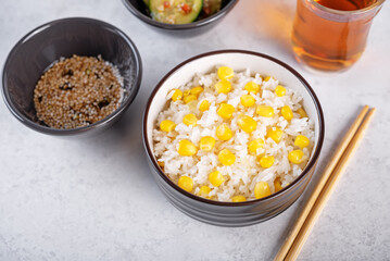 Asian corn rice in a bowl with cucumber salad