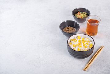 Asian corn rice in a bowl with cucumber salad