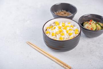 Asian corn rice in a bowl with cucumber salad