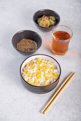 Asian corn rice in a bowl with cucumber salad