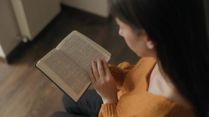 Devotional hands reading a Bible, symbolizing faith and worship