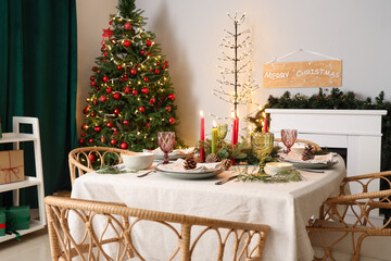 Festive table setting with Christmas decorations, pine cones and burning candles in dining room