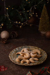 Delicious homemade Christmas cookies. Festive decorated sweets with lights, decorations. Vanillekipferl are Austrian crescent-shaped biscuits made from almonds and hazelnuts. Austrian German cuisine