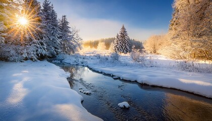 early morning sunlight reflected in a tranquil stream in a serene winter landscape with snow covered trees