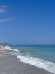 Sunny beach day with clear blue skies and gentle waves. Porto Sant'Elpidio, Italy.