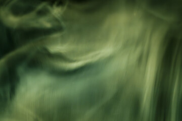 Abstract image of flowing green smoke patterns against a dark background, evoking a calm and mystical atmosphere with subtle motion and texture.