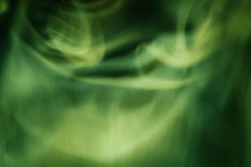 Abstract image of flowing green smoke patterns against a dark background, evoking a calm and mystical atmosphere with subtle motion and texture.