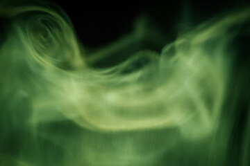 Abstract image of flowing green smoke patterns against a dark background, evoking a calm and mystical atmosphere with subtle motion and texture.