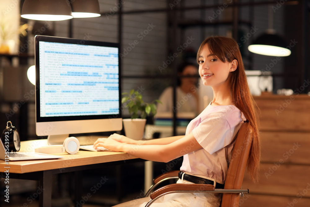 Wall mural female programmer working with computer in office at night