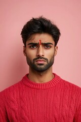 Fototapeta premium A person wearing a distinctive red cross mark on their forehead