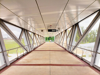 long walkway to an elevated subway station with a glass roof in Ashburn, Virginia.