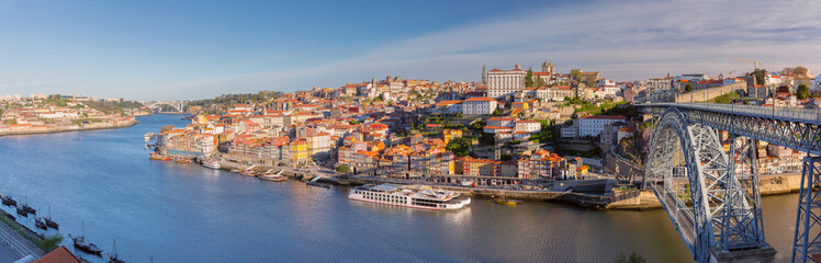 Douro River with colorful riverside buildings, traditional boats Porto, Portugal