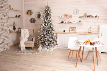 modern spacious kitchen with a large, bright window decorated for the New Year and Christmas