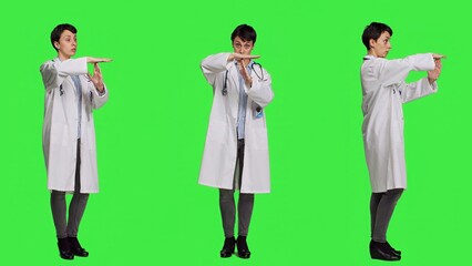 Woman physician doing timeout gesture against greenscreen backdrop, asking for a work break after multiple examinations. Doctor showing pause or stop symbol, feeling tired. Camera A.