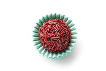 Delicious chocolate truffle in blue paper cup on white background