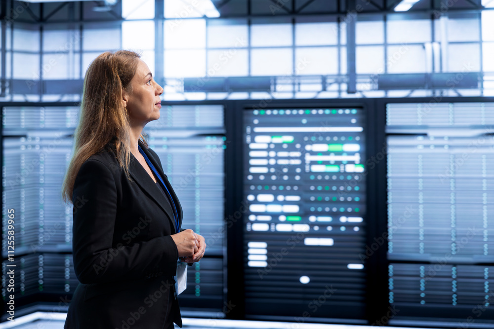Poster engineer walking between server rows in data center, doing yearly infrastructure inspection. system 