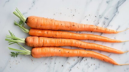 A bunch of carrots sit on a polished marble surface