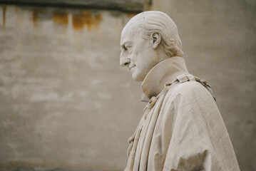 Statue of a man in front of church in Italy.
