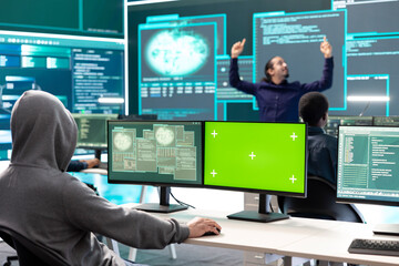 Professional team of governmental hackers conducting cyber surveillance, looks at isolated copy space screen. Expert examines cybersecurity measures and online security in high tech agency.