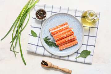 Plate with tasty crab sticks, dill and bowl of peppercorns on white background © Pixel-Shot