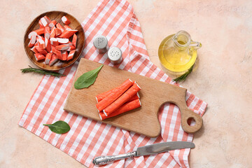 Wooden board and plate with tasty crab sticks on beige background © Pixel-Shot