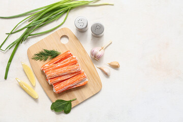 Wooden board with tasty crab sticks, dill and pieces of lemon on white background © Pixel-Shot