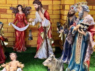 Christmas nativity scene with family. Christmas Manger scene with figurines including Jesus, Mary, Joseph, sheep and magi.