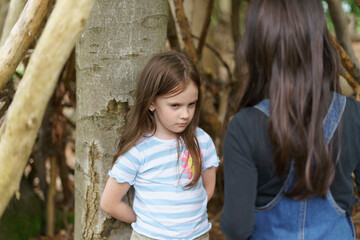 Two girls quarreling in the forest. Concept of complex relationships between children