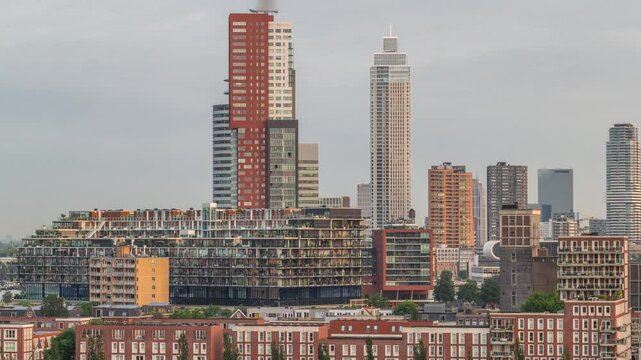 Aerial timelapse of Katendrecht peninsula and Maashaven harbour in Rotterdam, The Netherlands. City skyline at morning with warm light, modern skyscrapers and traditional Dutch waterfront houses