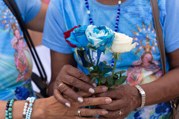 Catholics are seen holding roses during a tribute to Our Lady of Conceicao da Praia in the city of Salvador, Bahia.