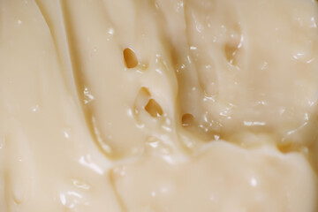 Close up texture of mayonnaise. Mayonnaise is an emulsion of oil, egg yolk and an acid either vinegar or lemon juice