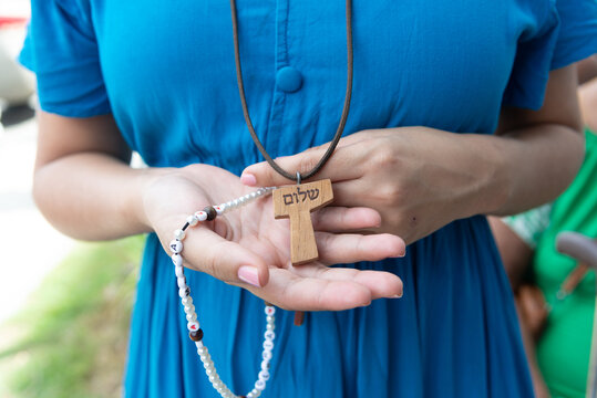 Detail of the hands of a Catholic believer during a tribute to Our Lady of Conceicao da Praia in the city of Salvador, Bahia. - Powered by Adobe