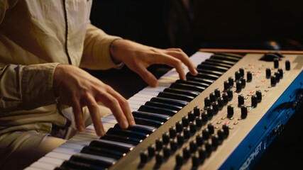 Talented artist performing in control room at studio and recording music for new album, working...