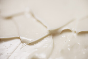 Close up texture of mayonnaise. Mayonnaise is an emulsion of oil, egg yolk and an acid either vinegar or lemon juice
