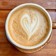 Heart Latte Art in White Coffee Cup on a Wood Table