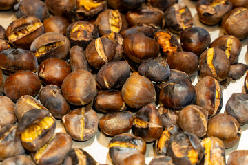 Close-up with out of focus background of typical Christmas roasted chestnuts.