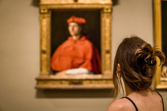 Foreshortening of a Woman Admiring the Beauty of a Medieval Painting in a Museum