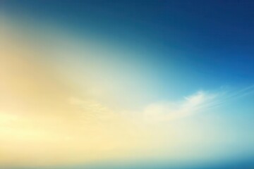 Obraz premium A serene gradient of blue and gold, evoking calmness and tranquility in the sky.