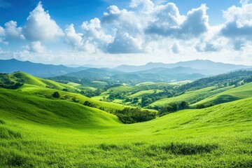A serene landscape showcasing rolling green hills under a bright sky with scattered clouds.