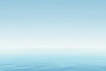 Obraz premium A serene seascape with calm waters blending into a clear blue sky.