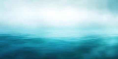 Obraz premium A serene seascape with gentle waves and a misty horizon in soothing blue tones.