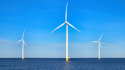 Windmill park in the ocean, drone aerial view of windmill turbines at sea in the Netherlands