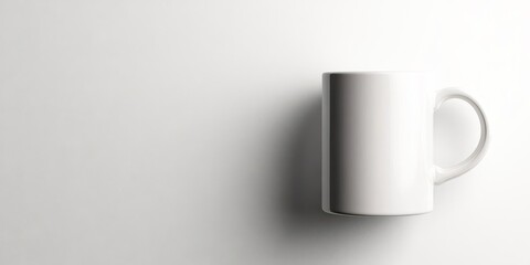 Obraz premium A simple white mug placed against a light background, highlighting its minimalist design.