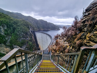 Gordon Dam in Tasmania, an impressive concrete structure surrounded by rugged cliffs and a lake in...