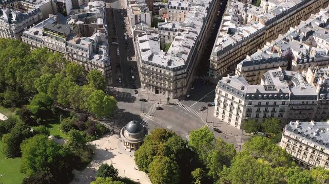 PARIS, FRANCE - OCTOBER 3, 2024: Aerial view of bustling city streets and elegant architecture surrounded by lush trees